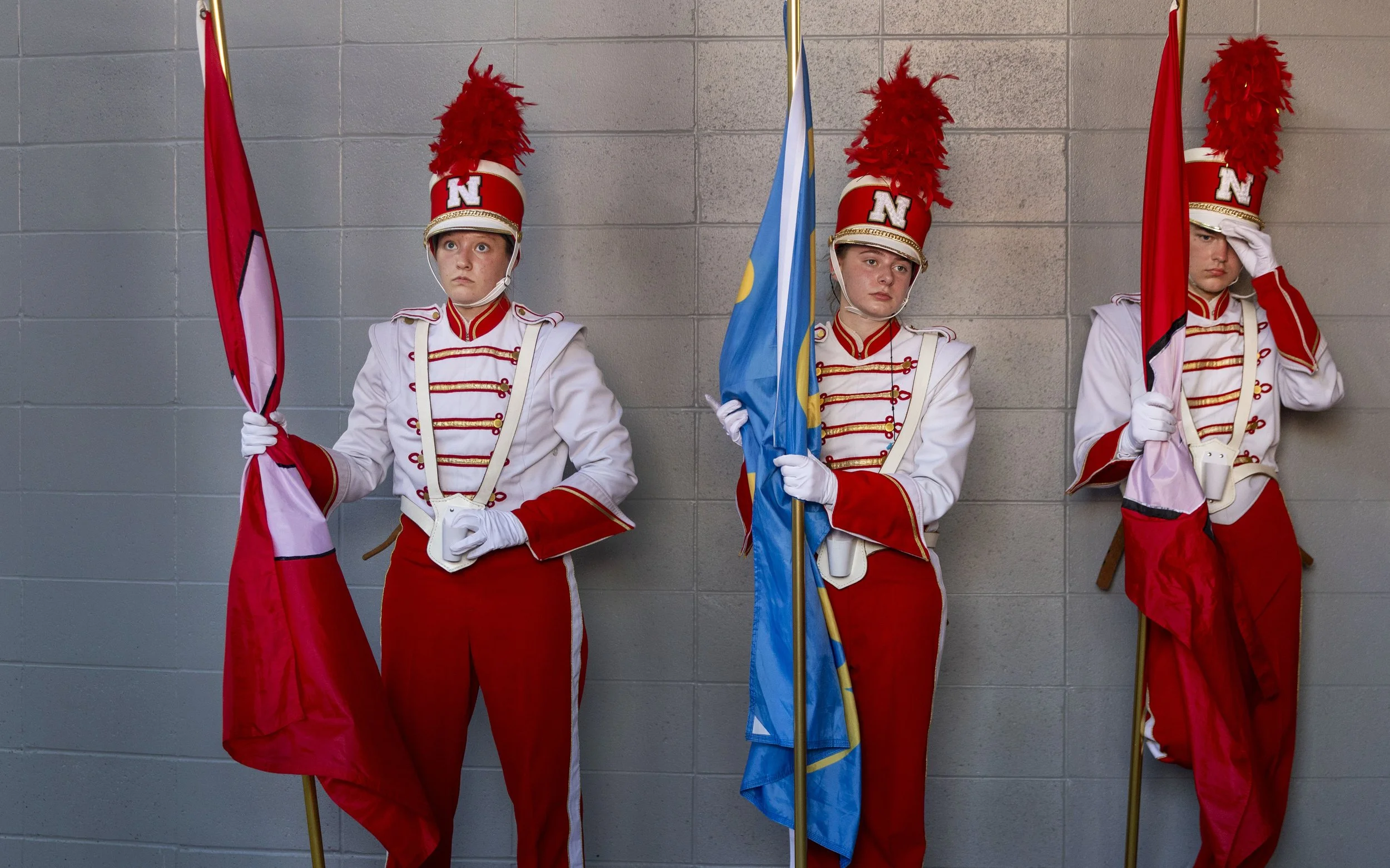 Nebraska Cornhusker marching band flag-bearers wait to take the field before the game on Saturday, Oct. 4, 2025, at Memorial Stadium.