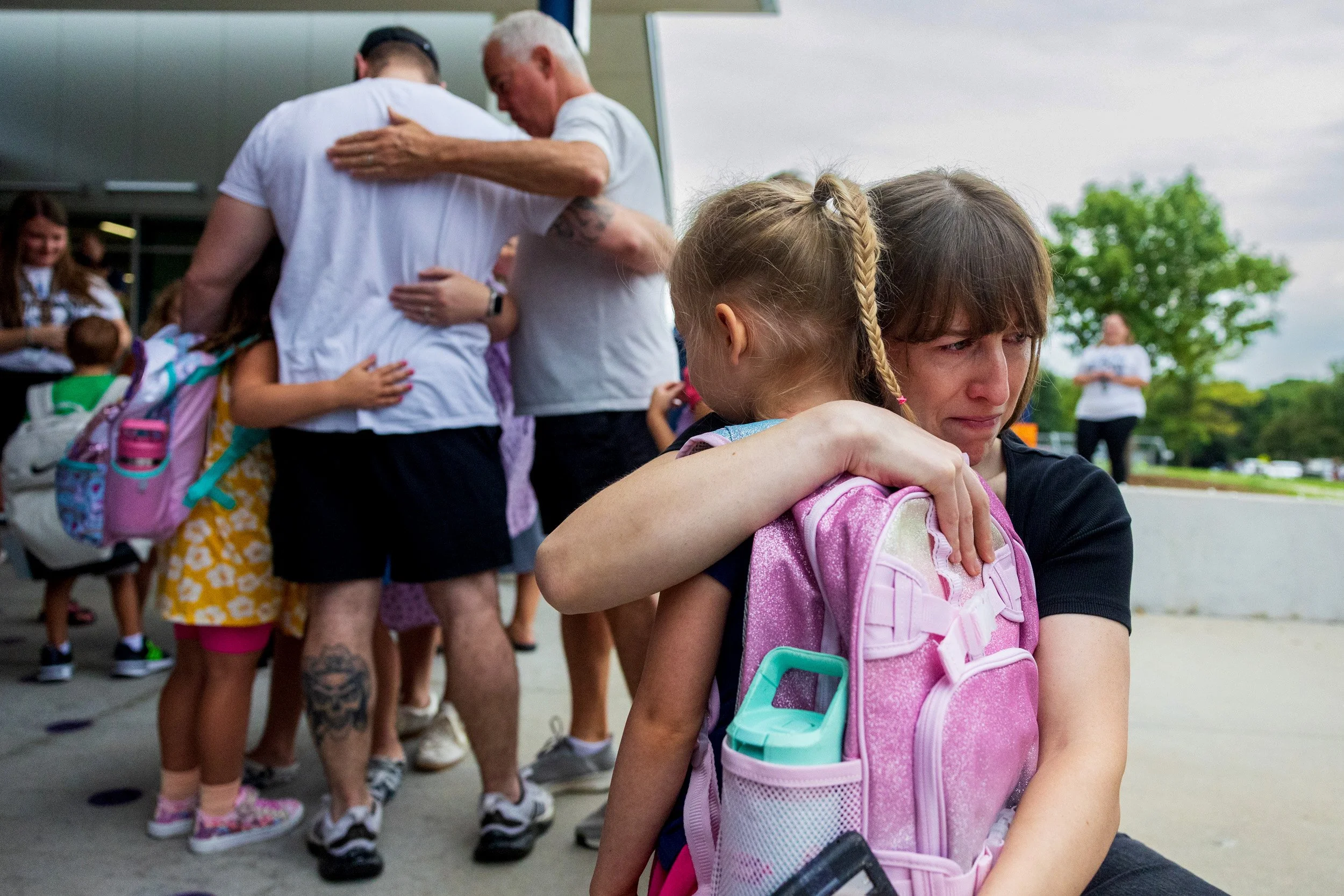 Becky Henderson, far right, hugs Isla Kinnison tight as she says goodbye to her before the first day of kindergarten at Humann Elementary School on Wednesday, Aug. 12, 2026, in Lincoln.
