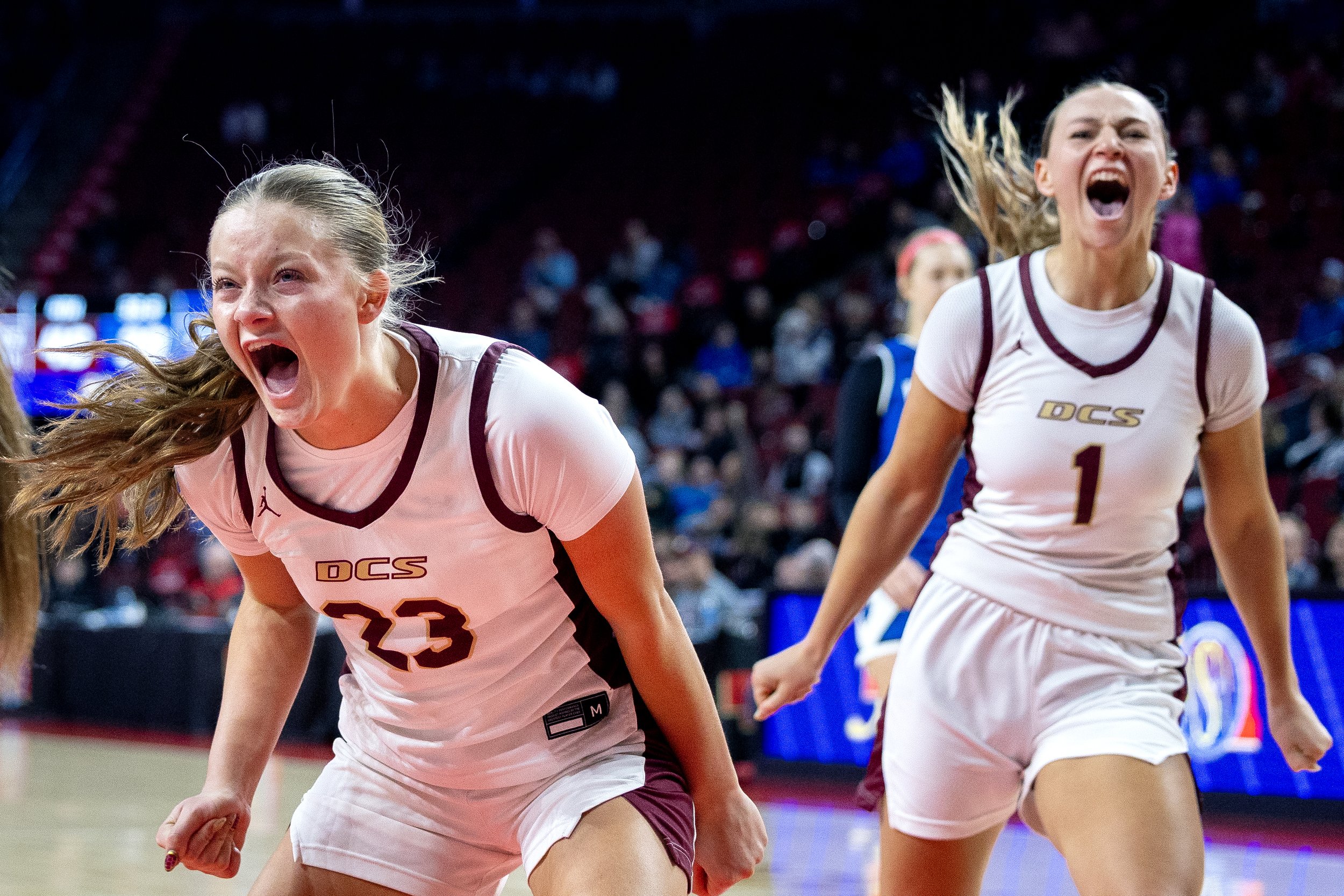 Dundy County Stratton’s Ava Lutz (23) and  Clara Spargo (1) celebrate as Abi Spargo, not pictured, secures the final basket to beat Wynot during the Class D-2 state championship game Saturday at Pinnacle Bank Arena.