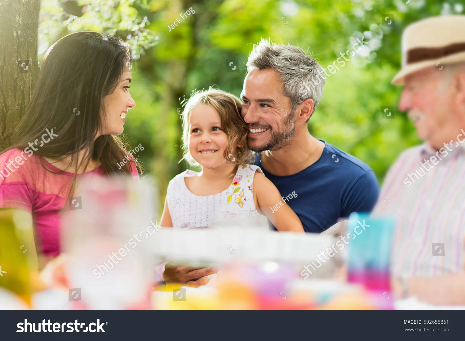 stock-photo-three-generations-family-gathered-to-lunch-in-the-garden-in-summer-they-having-fun-sitting-around-592655861.jpg