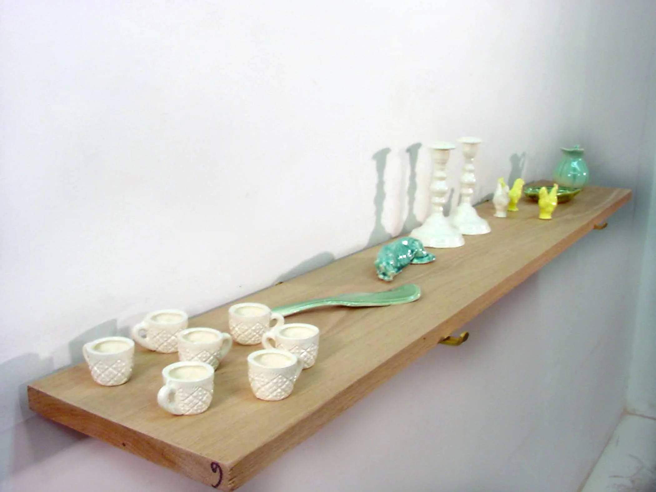 View of objects cast from my grandmother, 2004, slipcast porcelain, glaze, wooden shelf.