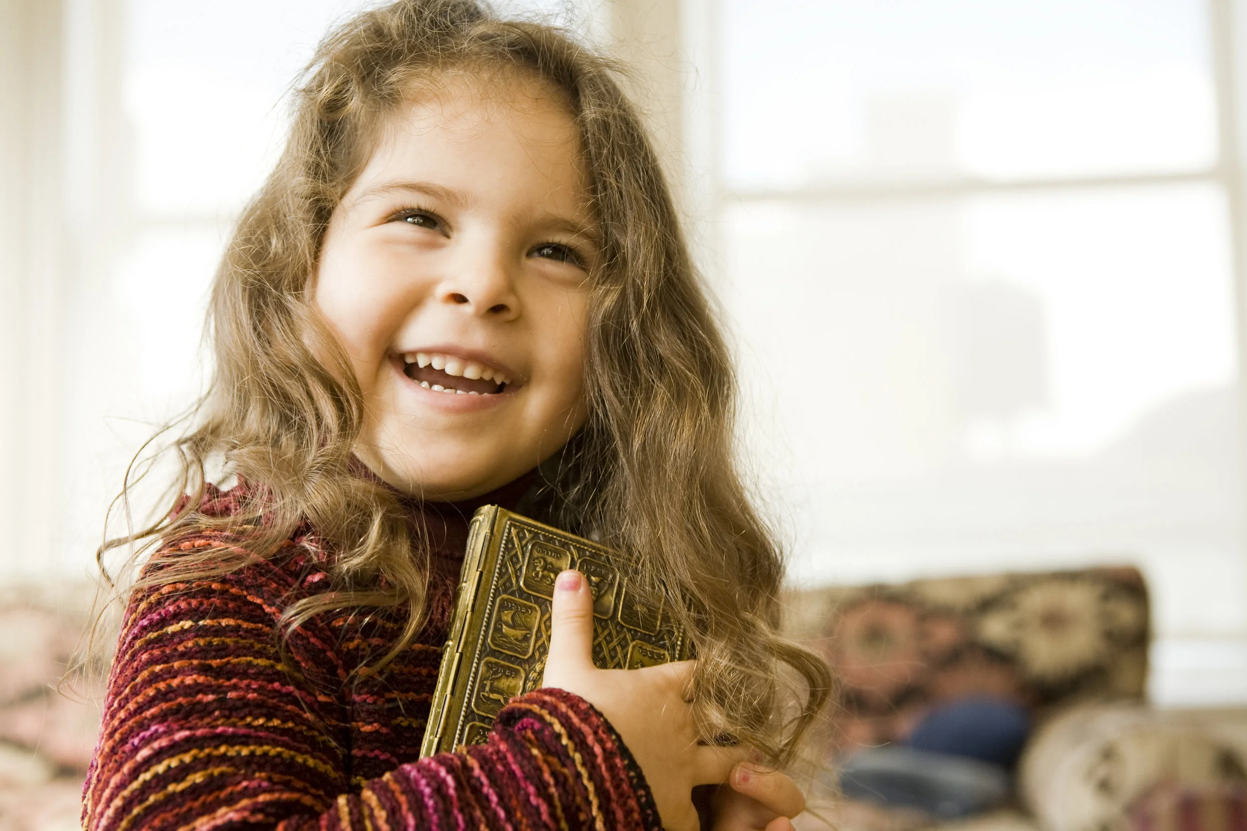 Laughing, Smiling, Girl Hugging a Prayer Book.jpg
