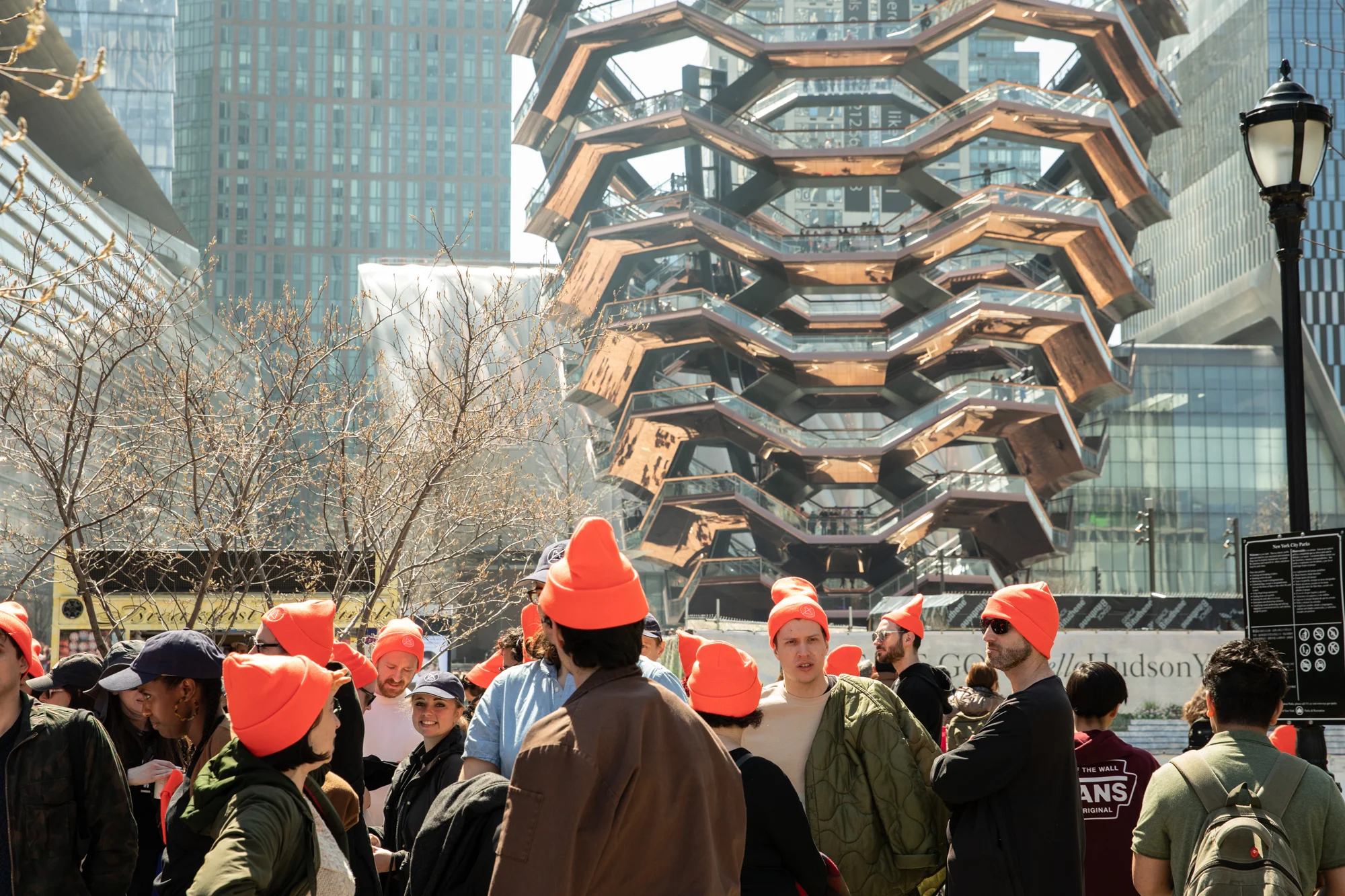 A sea of orange hats with the Vessel in the background.