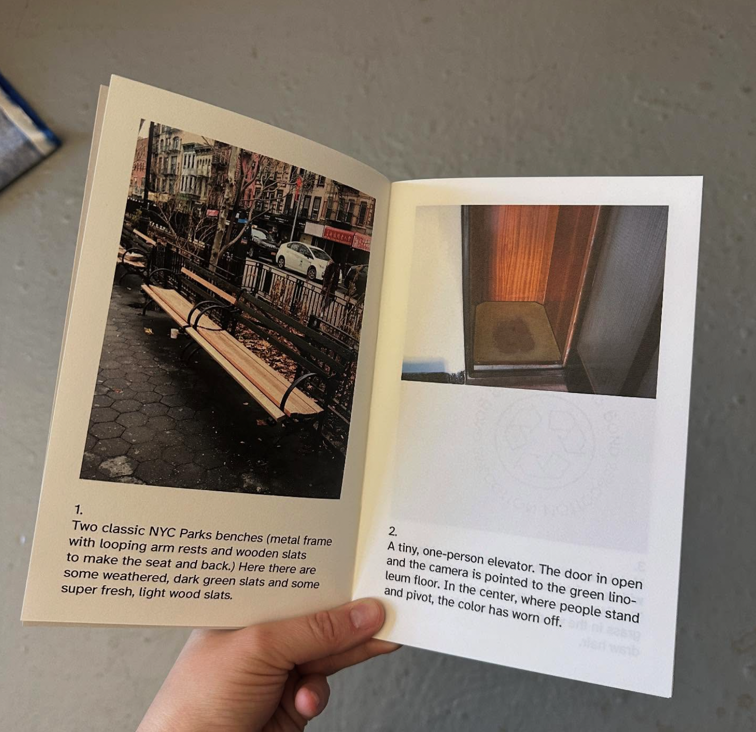 A hand holds the mood board open to an interior spread. Each page has an image and description. On the left, a photo of two NYC parks benches and on the facing page, a photo of a tiny one-person elevator.
