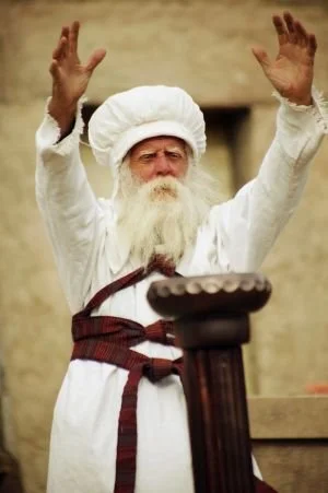 priest with arms outstretched