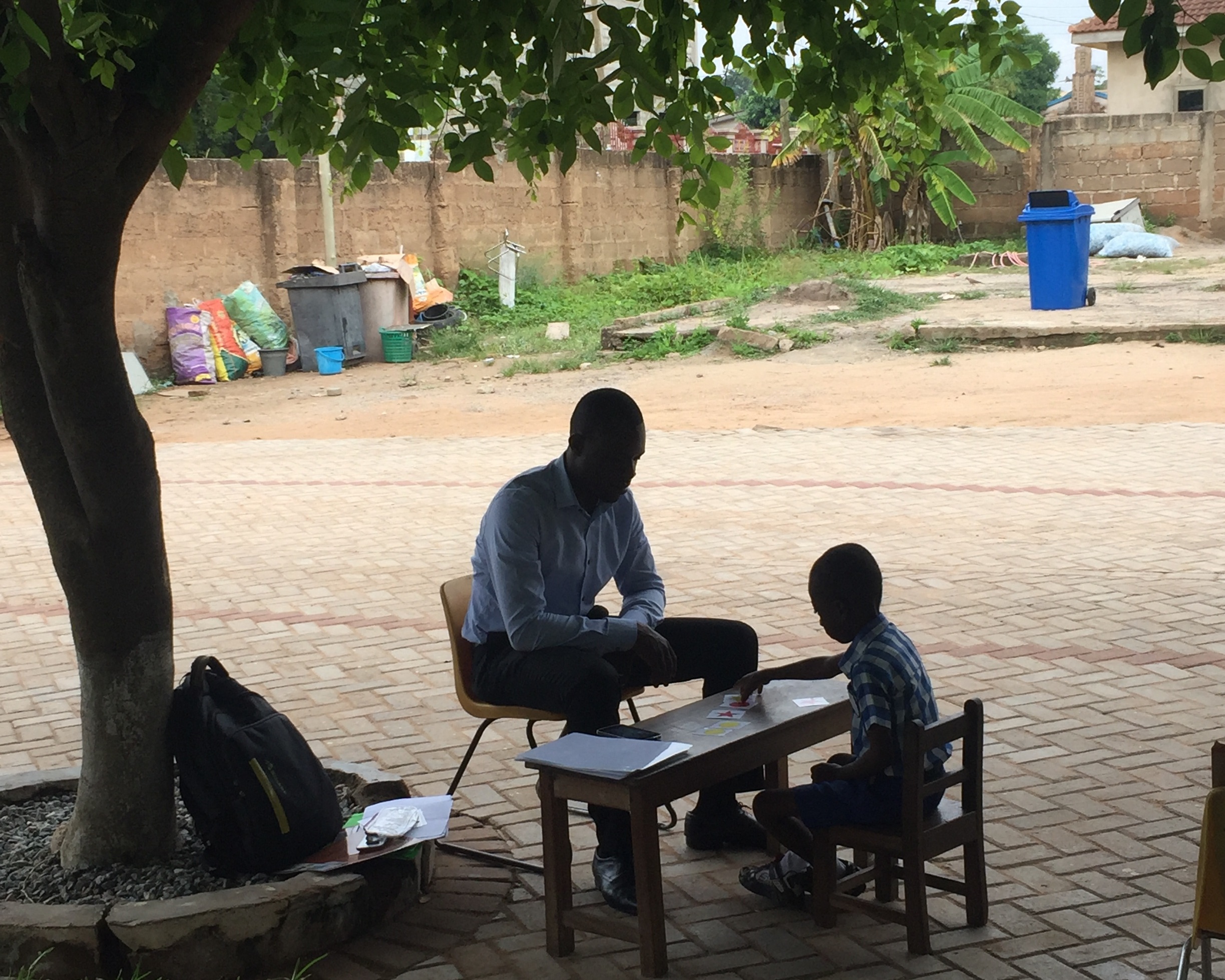 Enumerator (Maxwell) assesses student using IDELA at Bright School Complex, Accra, Ghana.