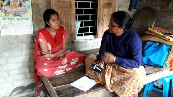 An IDinsight officer interviews a community member in West Bengal on her experiences with Aadhaar.