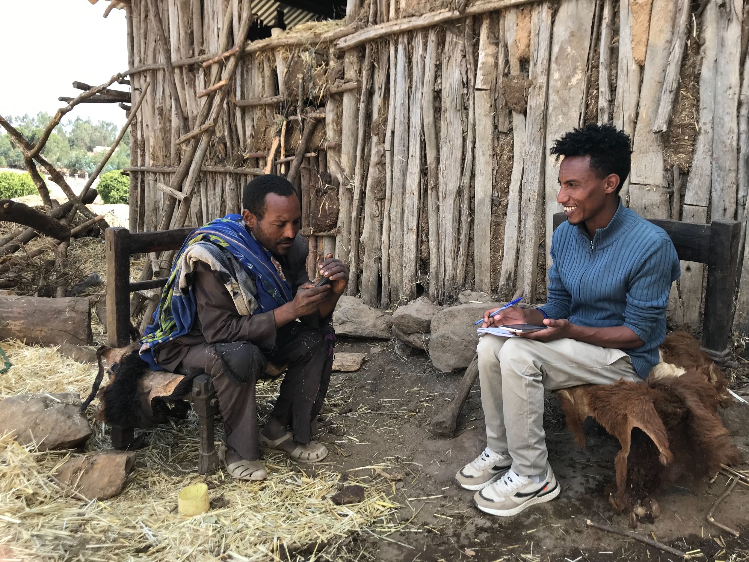 Markeshaw Dessie, an IDinsight data collector (right) conducts a survey about asset ownership in Wogera district, Amhara, Ethiopia