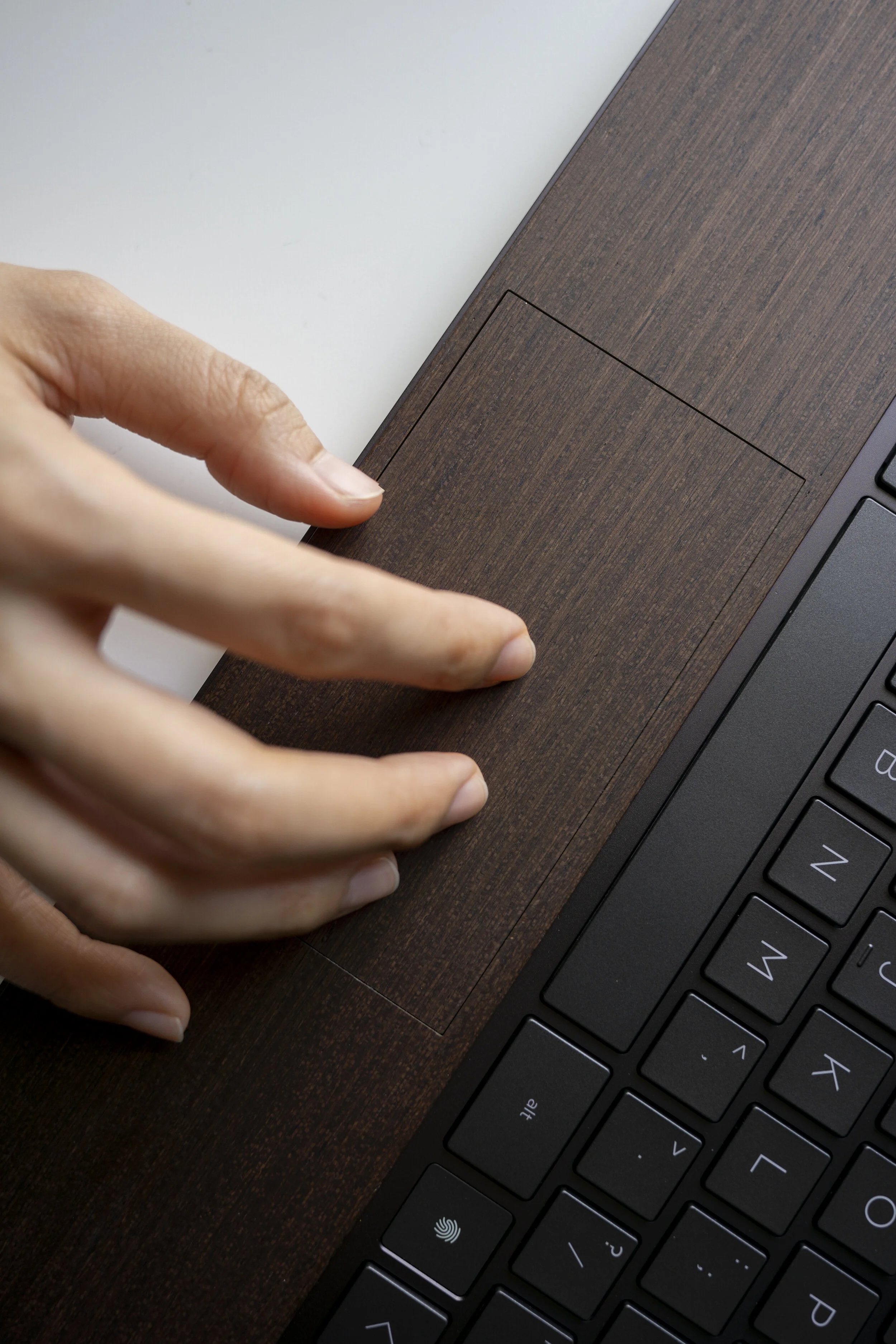  We wanted to make the material feel more structural, something the original lamination process was incapable of. To solve this, we re-engineered the wooden process using insert molding to raise and reveal the wood above the normal keyboard deck. We 