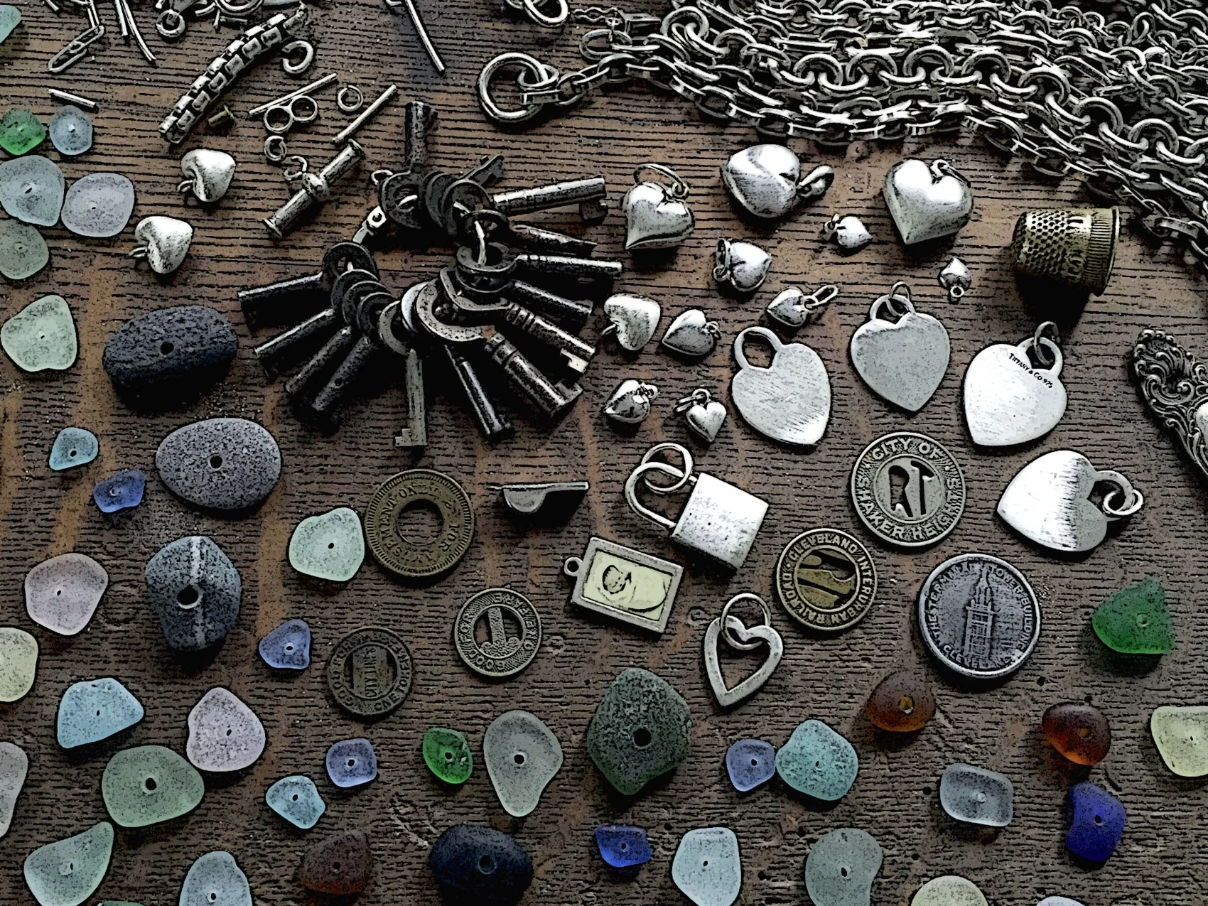 Sea glass, beach stones, vintage silver charms, chains, thimbles, tokens, hearts, locks, keys, silverware, and vintage beads all find their way into SToNZ Jewelry creations.