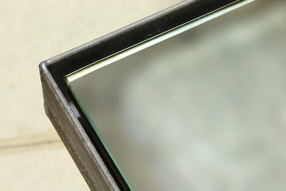 Steel float frame hosting a mirror
