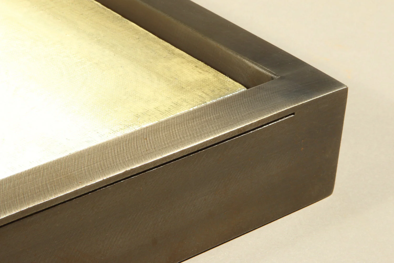 This sophisticated custom welded float frame features elegant thin groove that contrasts with edge thickness. Rather than a narrow width, the frame was designed to have a ½” face, to add more prominence to both the frame and the art piece.