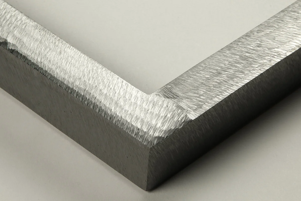 Detail of an 1” wide molding steel frame with ground gloss finish