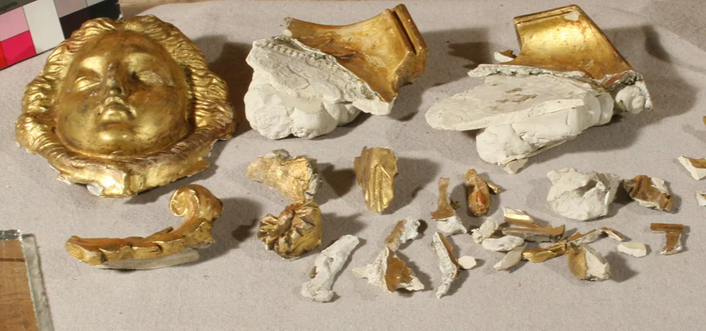 Gilt gesso, plaster, and composition elements that detached due to impact during shipment