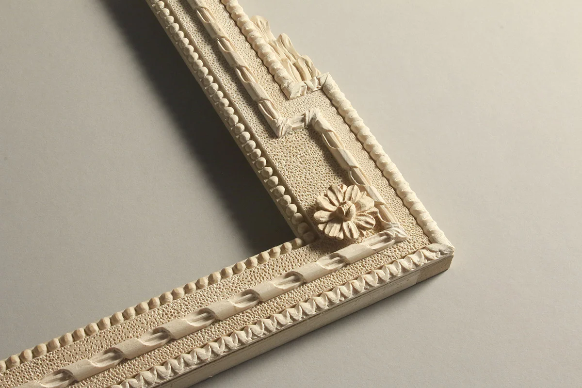 Hand carved corner of a decorative trumeau frame design. Note the asymmetric corner and the tactile quality that hand carving provides for the beaded, lamb’s tongue ribbon ornamentation.
