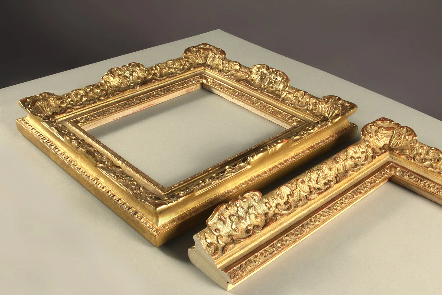 A Louis XIV revival design with a shallow ornate pattern adorning the rail. Note the intentional placement of decorative corner and central cartouches.