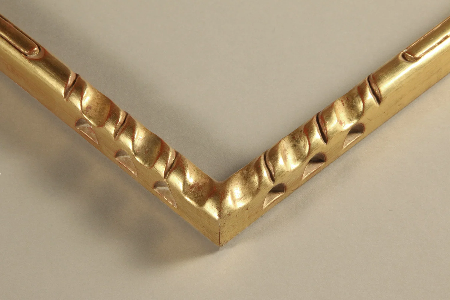 Contemporary carved and incised design on both the face and sides to create a play in the reflected light in the 23kt gold sheen and the shadowed recesses in the profile.