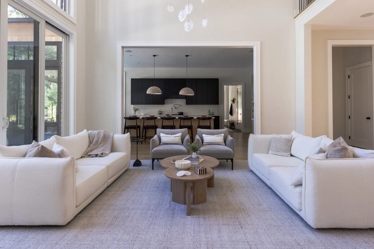 Perfect symmetry defines this living room, where every detail balances form and function. ⁠
⁠
Sofas and coffee tables by Maiden Home anchor the space, complemented by West Elm side chairs and a sleek black drink table from Crate and Barrel.