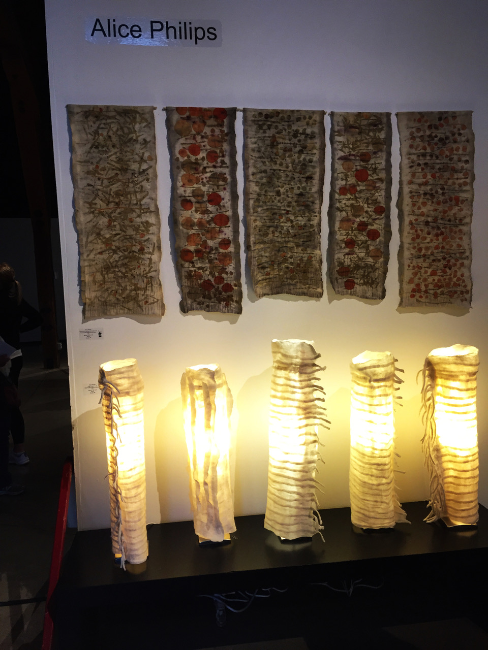 Tall felted lamps throwing off a golden light