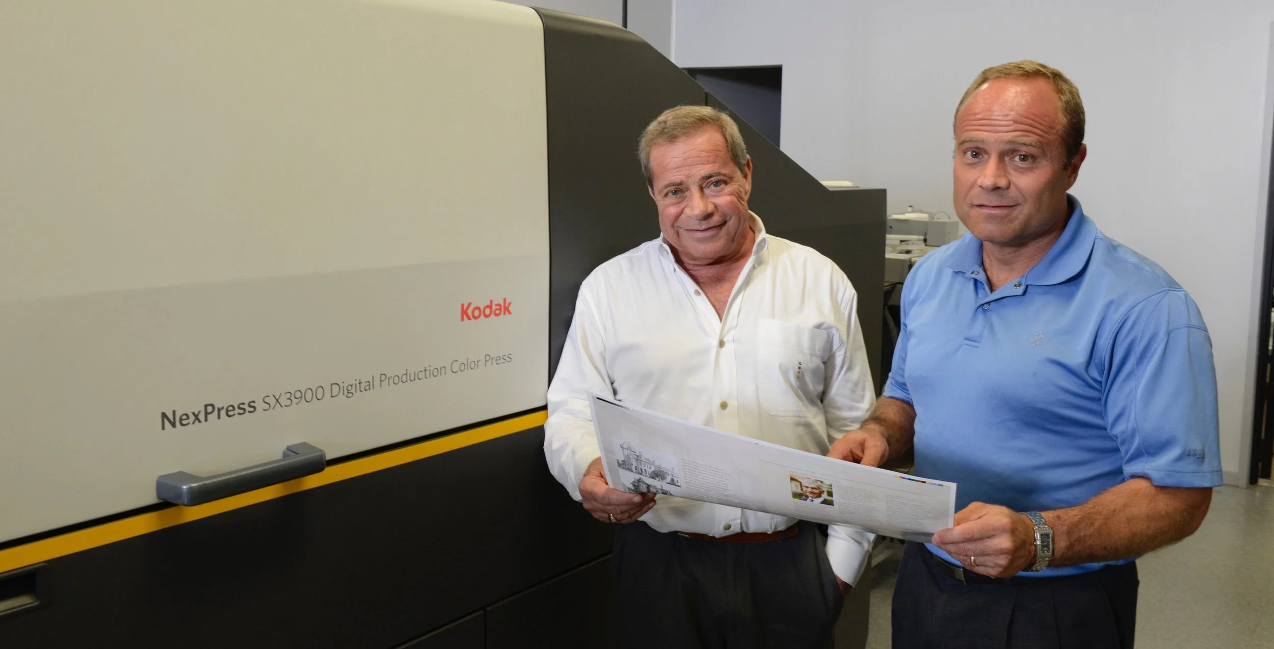 Skip DeBiase, founder of Phoenix Graphics, at left, with his son, Sal DeBiase, who continues his late father’s legacy today at the five-generation family printing company.