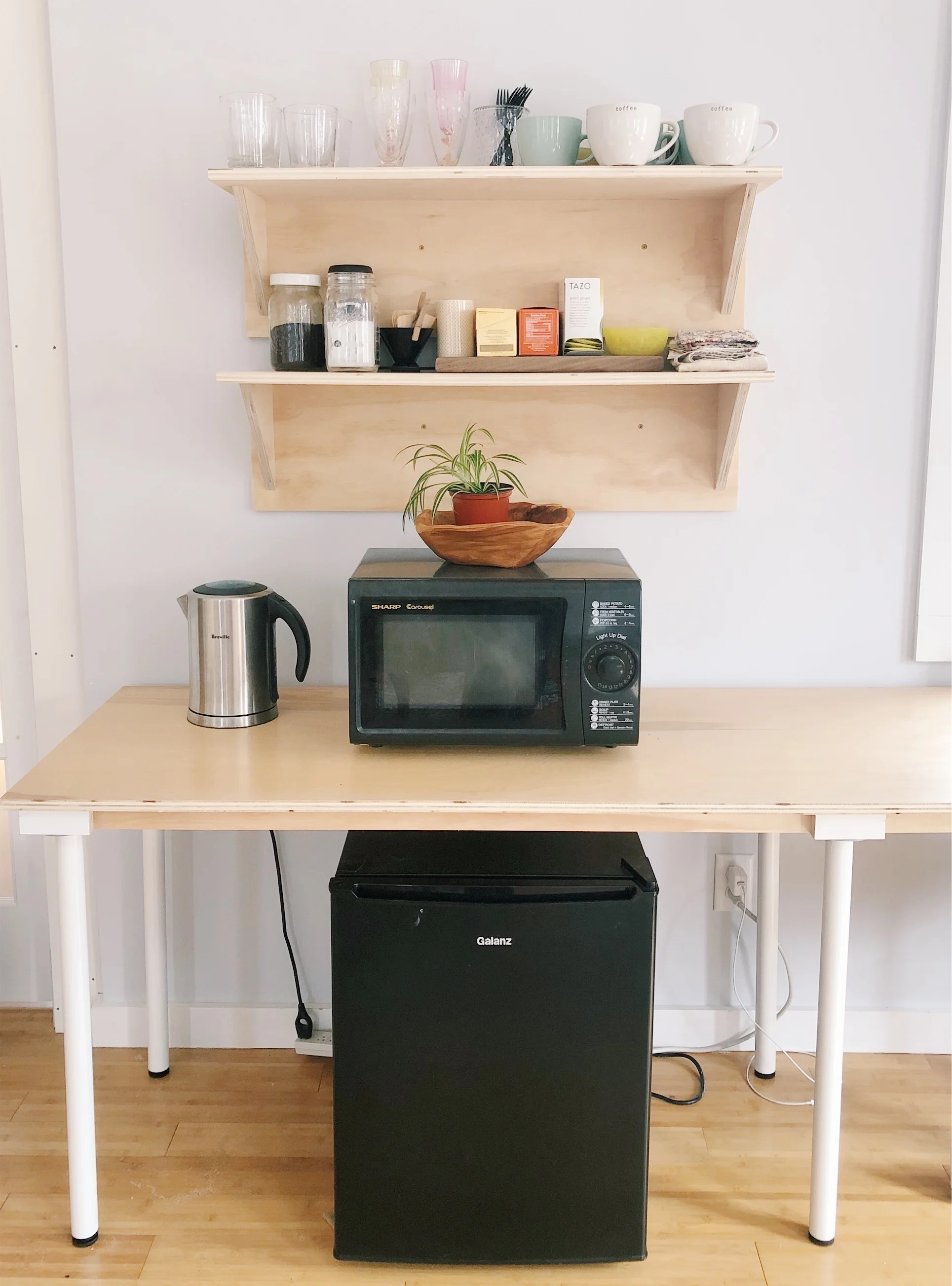 Kitchenette with electric kettle and mini-fridge.