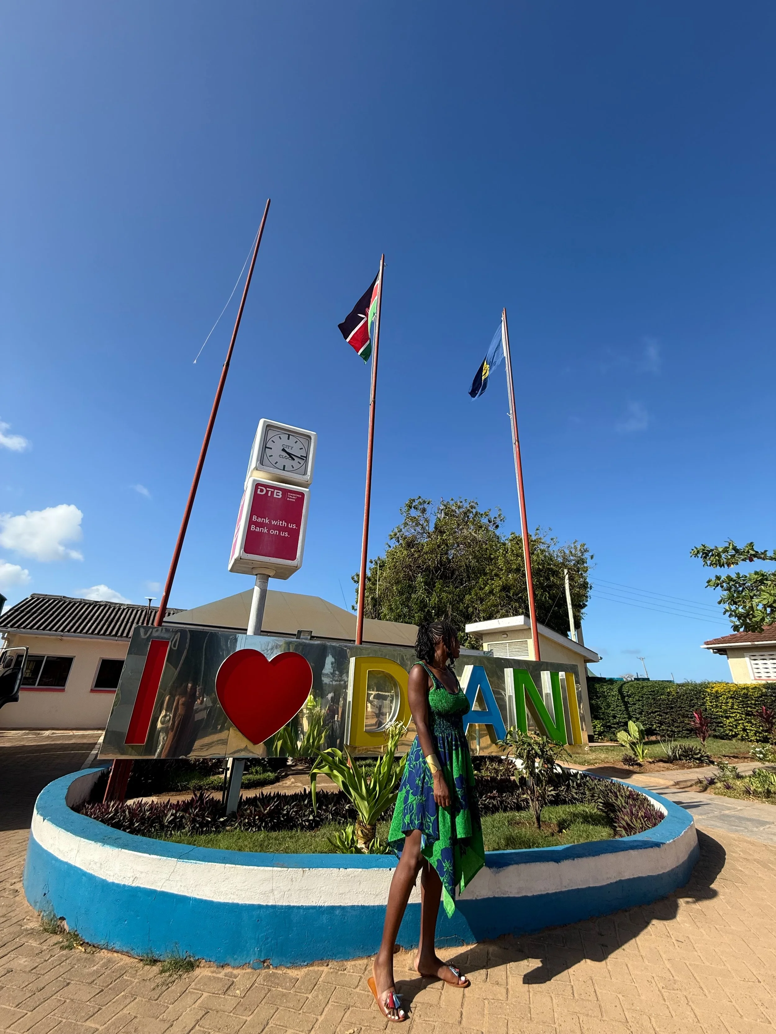 Kris infant of the I love Diani sign at the Diani Airport in Diani, Kenya