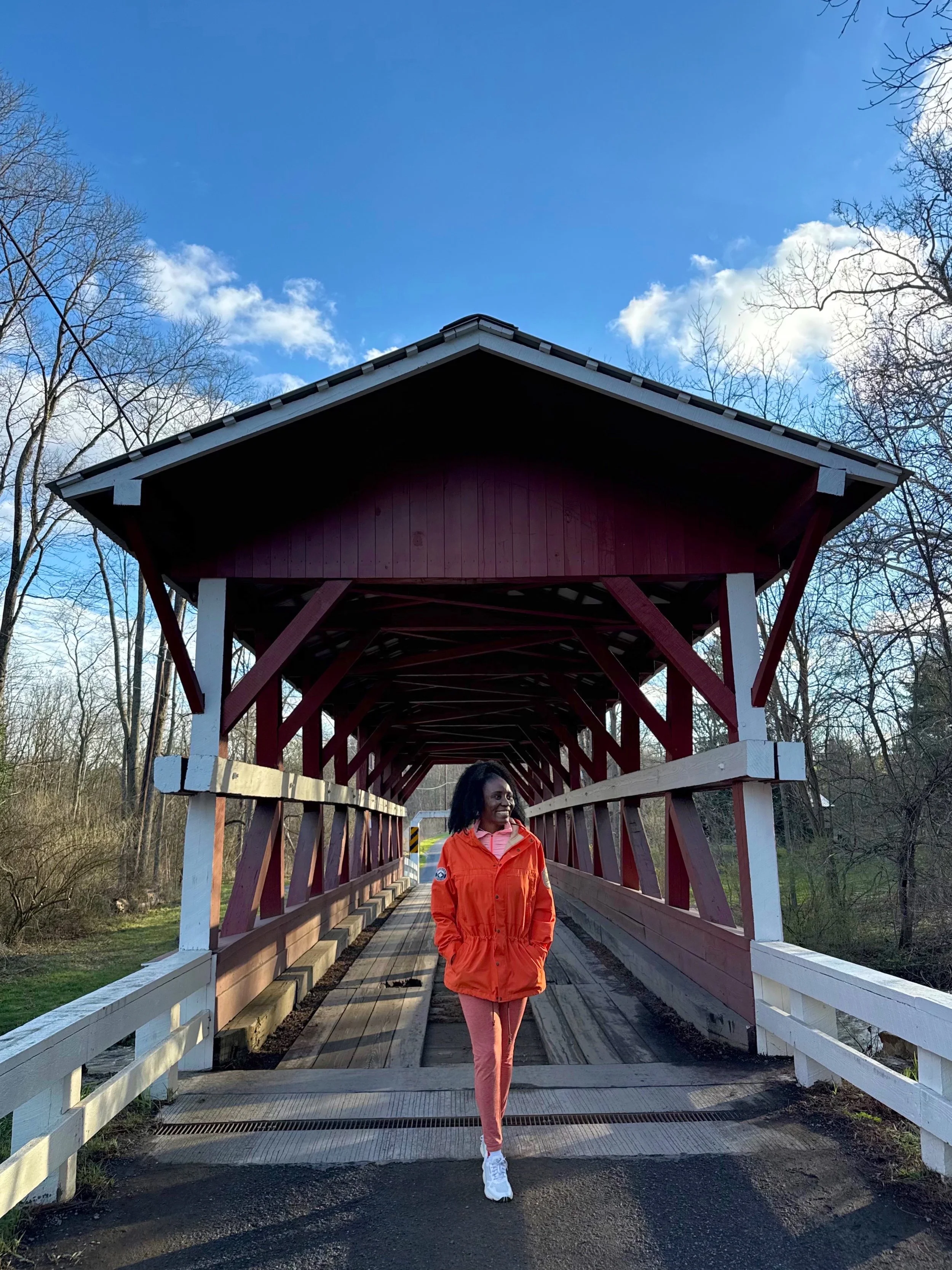 Christane standing in front of the Colvin Covered Bridge