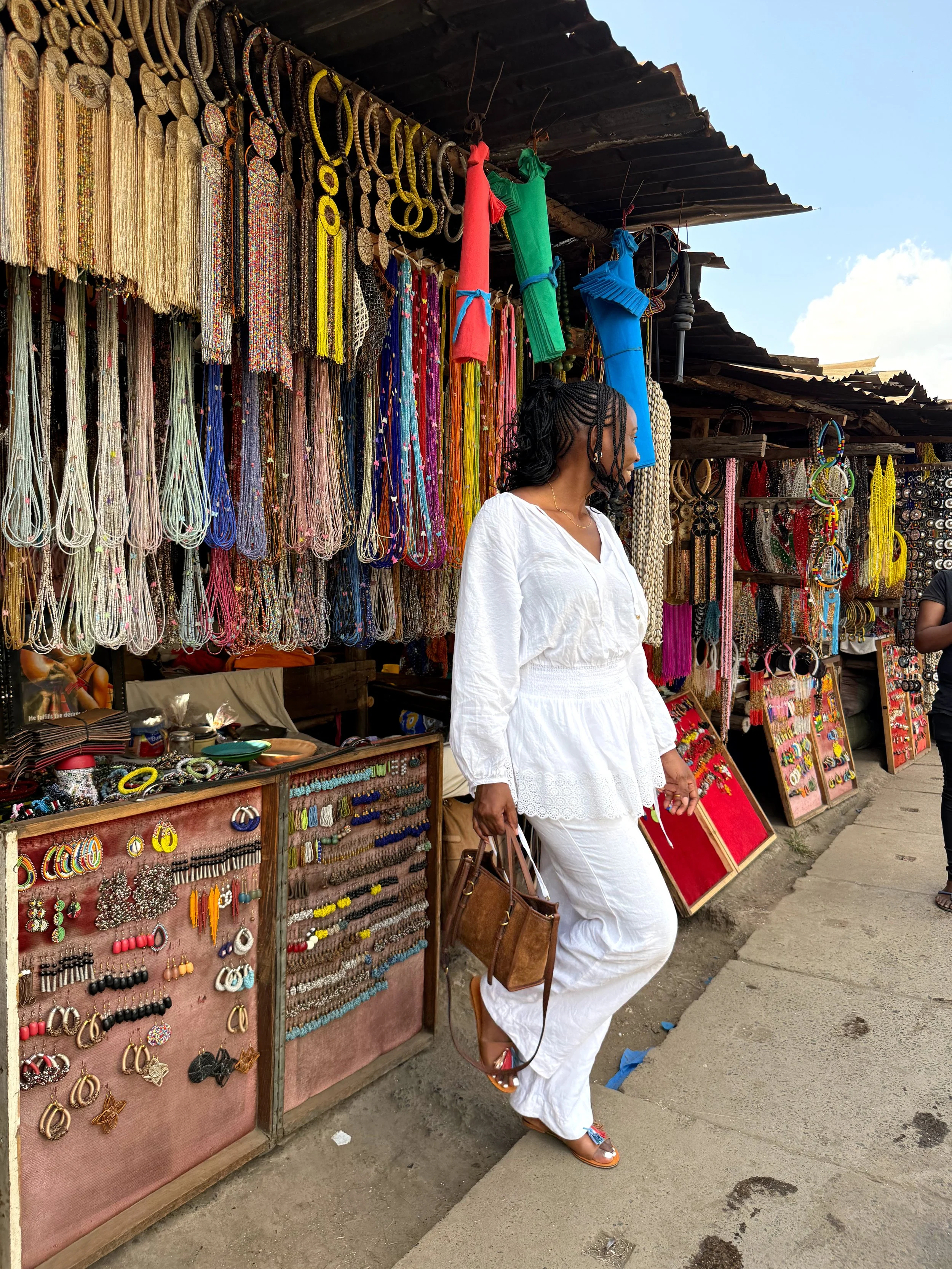 Kris at standing in front of an artisan at the Kariokor Market in Nairobi Kenya