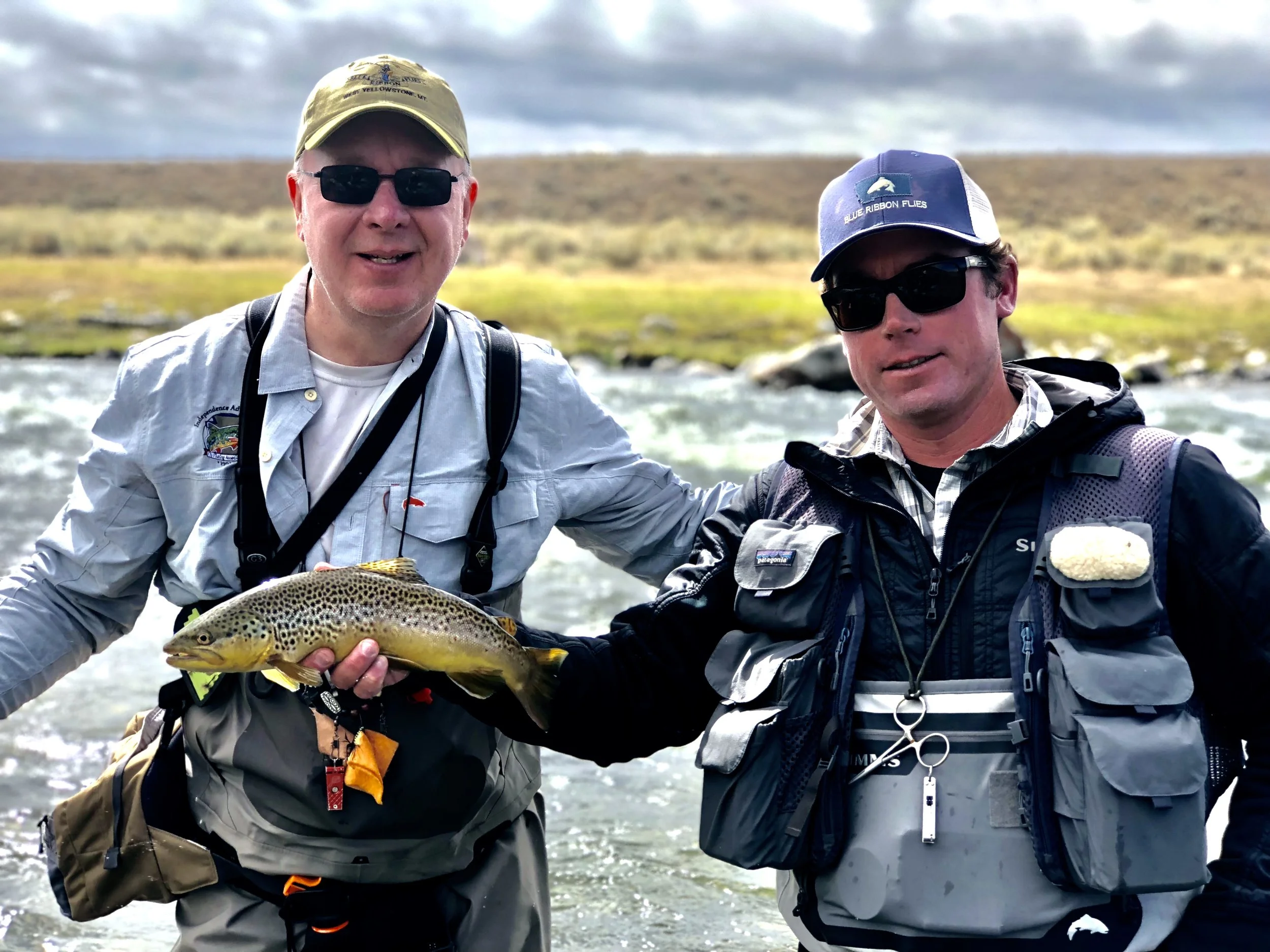 Blue Ribbon Guide Drew Mentzer holds up a quality brown trout taken on an Arrick’s Ant by Charles Boinske.