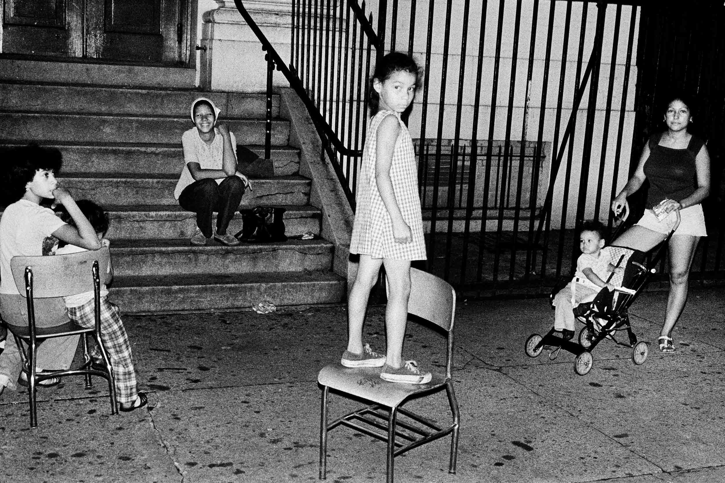 Sylvia Guadalupe (standing on chair), on Twelfth Street off Avenue A. From Alphabet City . 1977