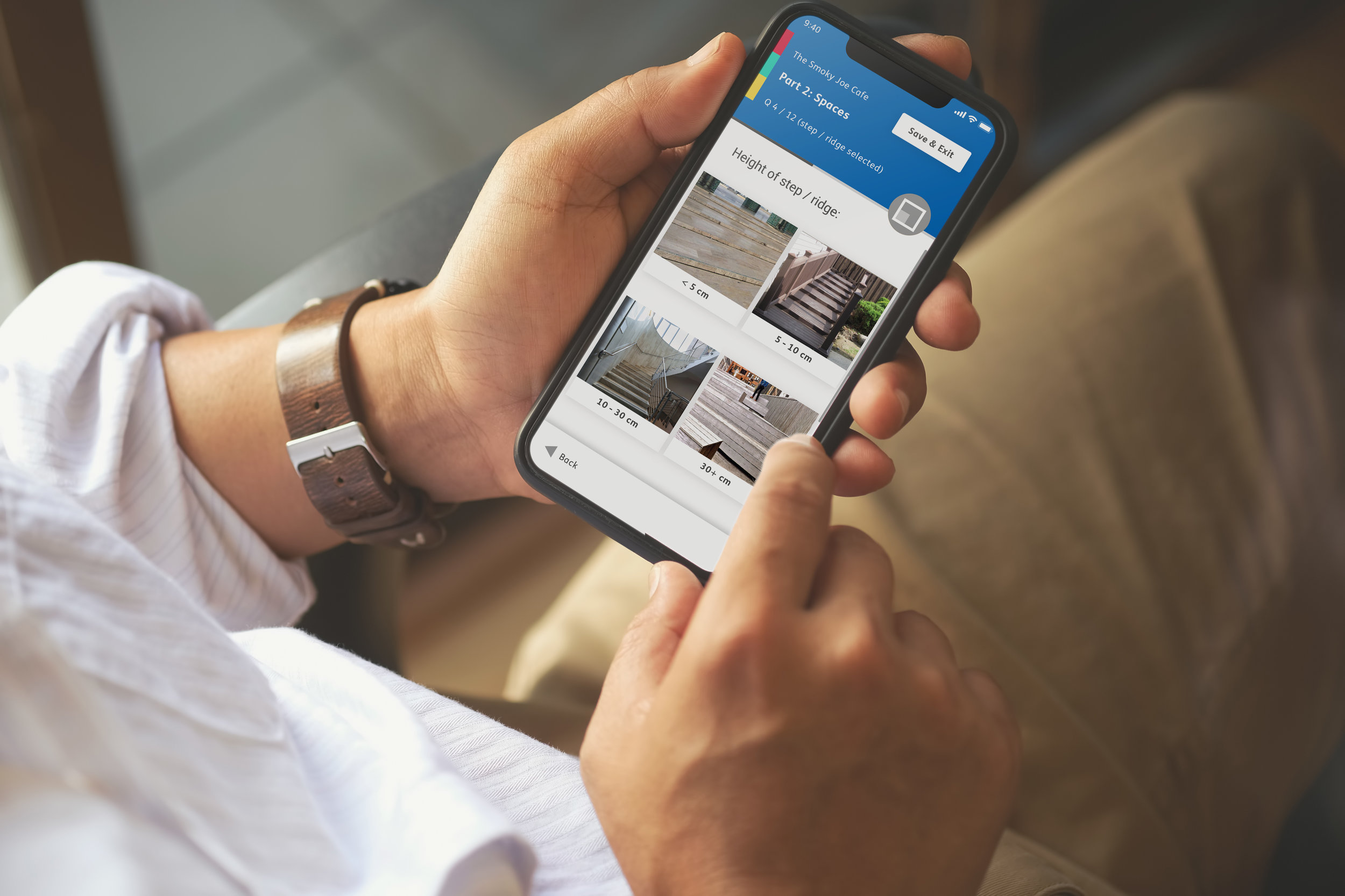 Image of a person holding an iPhone in their hand looking at a page of the SociAbility app.jpg