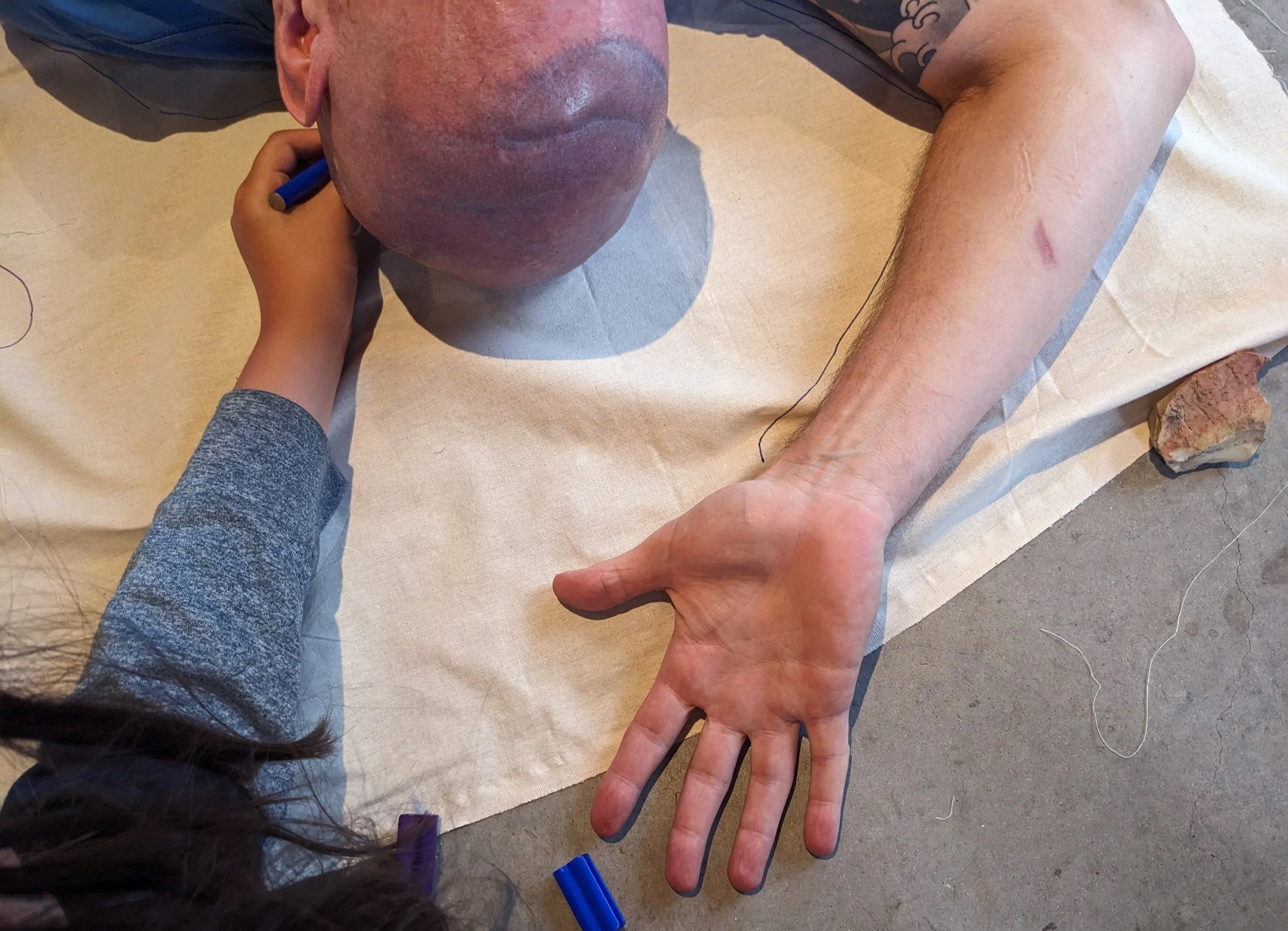 Figure 4. A daughter tracing her father’s outline..jpg