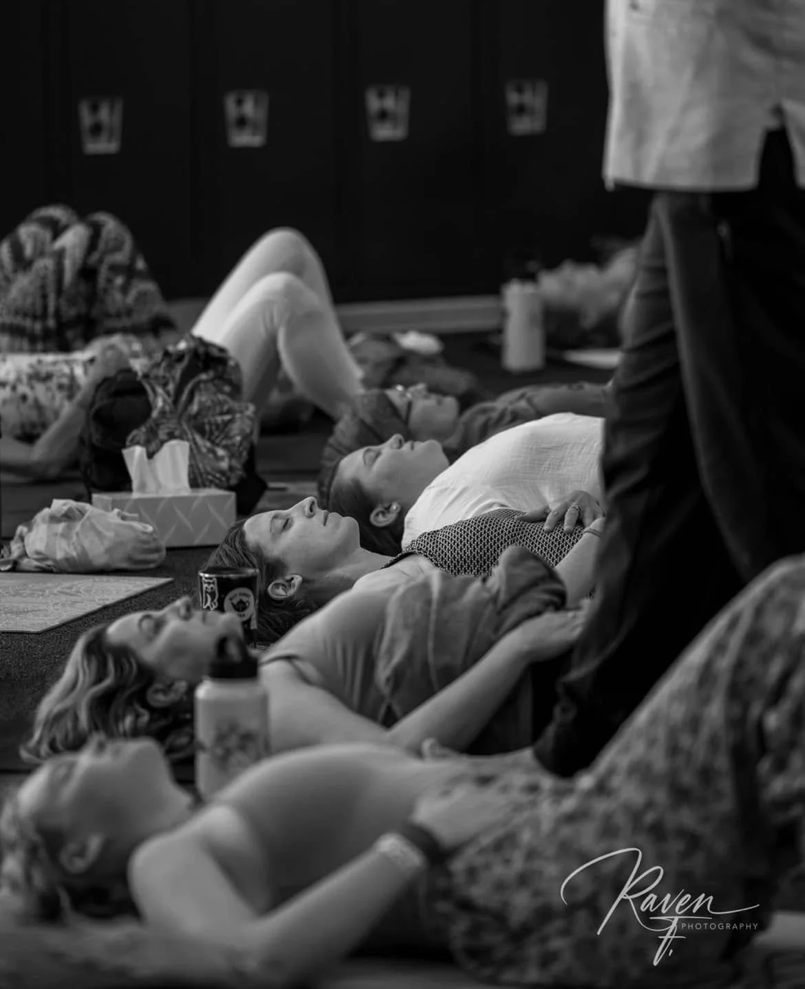 People lying on the floor in a room in child's pose.