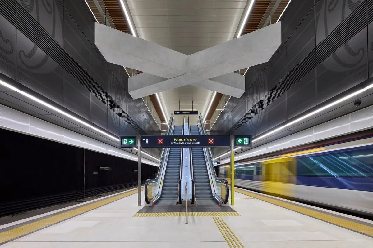 Escalator, white terrazzo tiles and yellow tactiles at Auckland Train stations