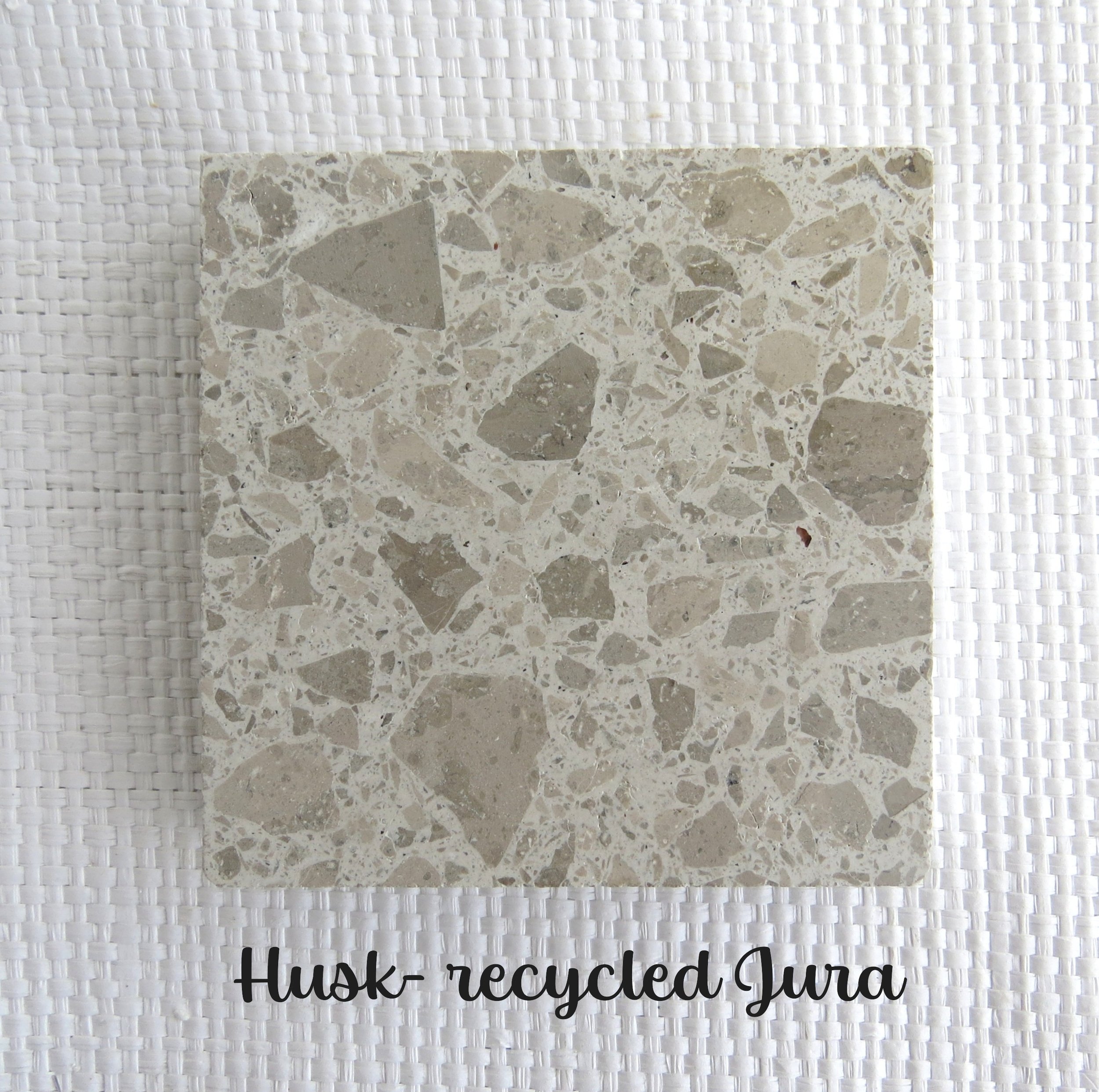 HUSK Tile- Nature has a wonderful way of providing a husk to protect its bounty. Natures skin. Recycled Jura in a white base with the hue of Jura