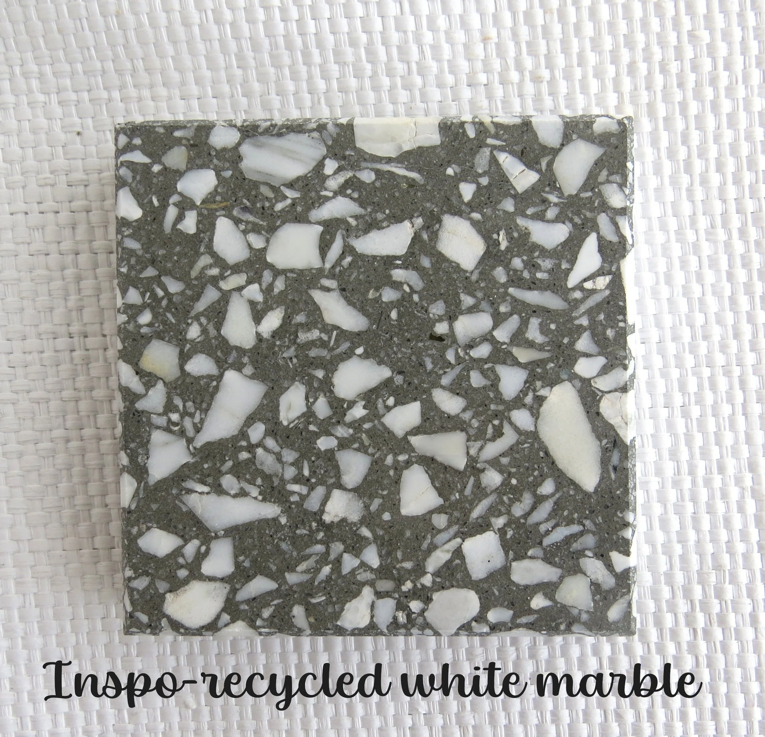 INSPO tile- RECYCLED Sometimes Inspiration comes to us in pieces at a time. It is up to us to acknowledge it and bring the pieces together to manifest it in our lives. Recycled White marble in a dark gray base