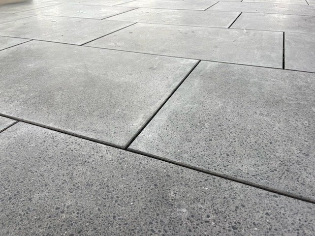 Close-up of gray concrete terrazzo pavers at the Mt Eden Train Station 