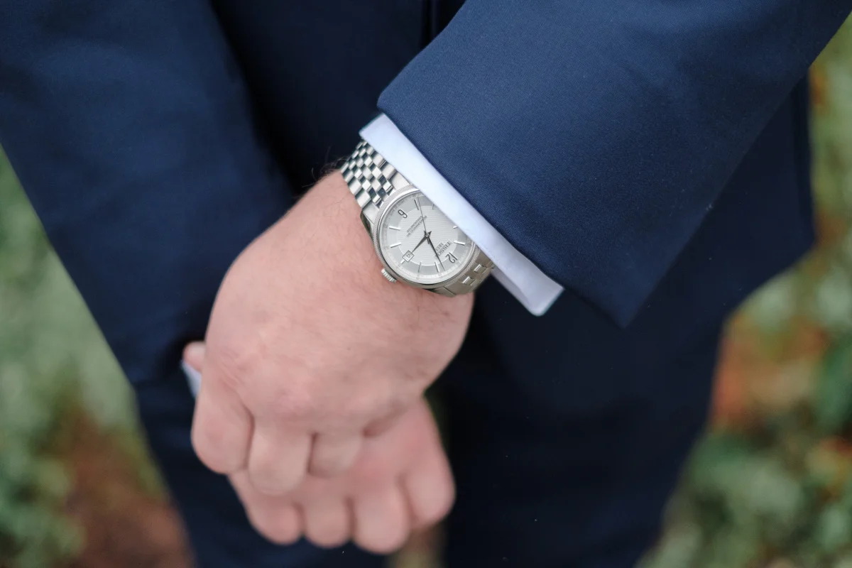 Groom details of watch and blue suit at Lake Geneva Resort