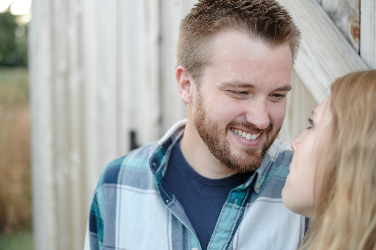fall engagement portrait with couple gazing into each others eyes in macktown forest preserve in rockton, illinois