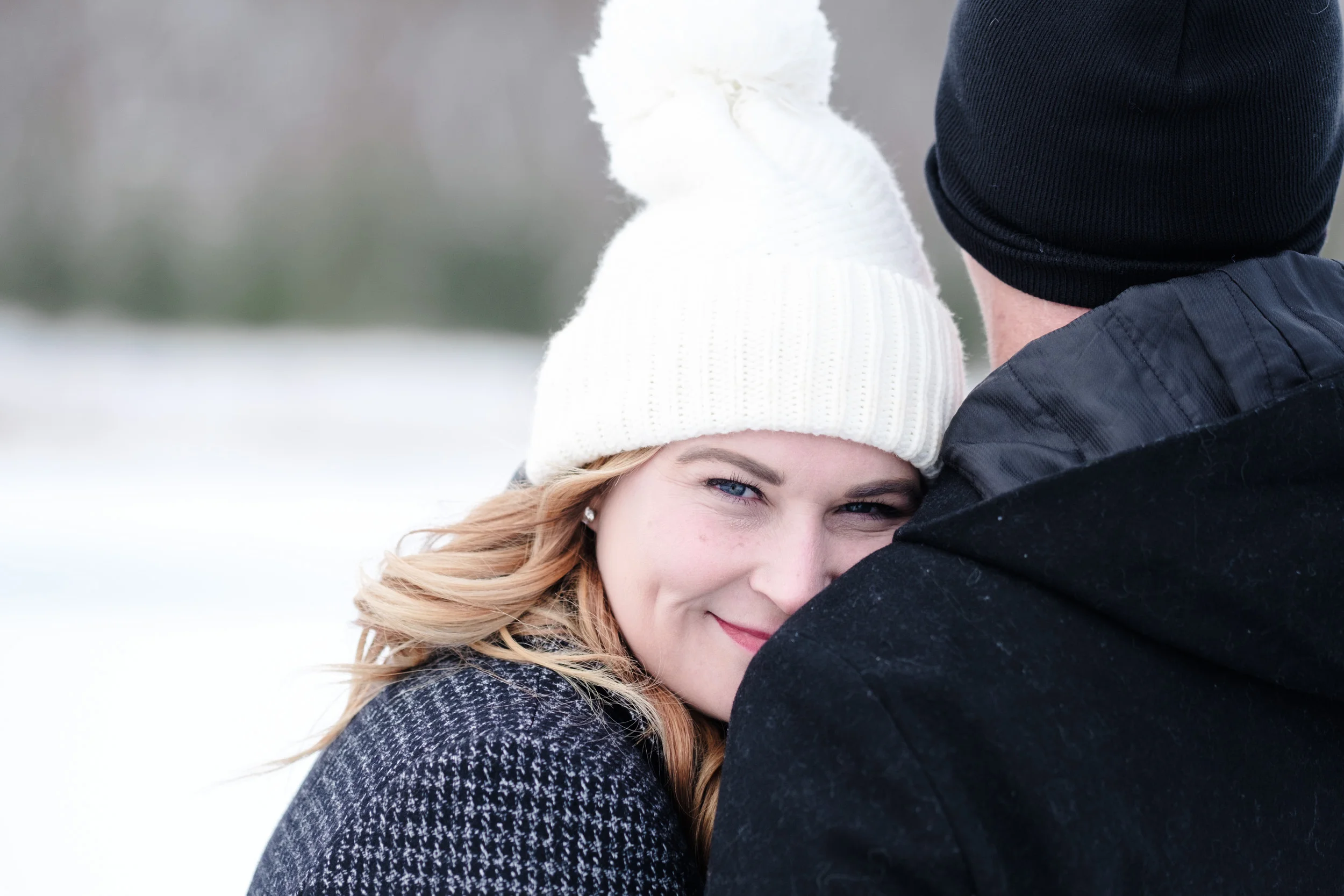 brides blue eyes as she looks back during engagement session in a winter wonderland at the pavilion at orchard ridge farms.