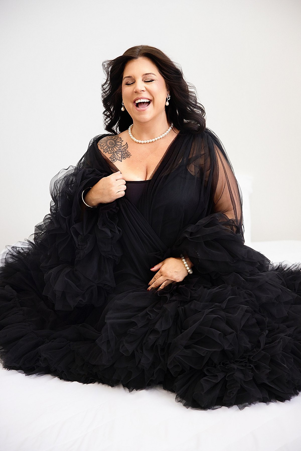 Boudoir-black-bed-laughing-candid-portrait.jpg