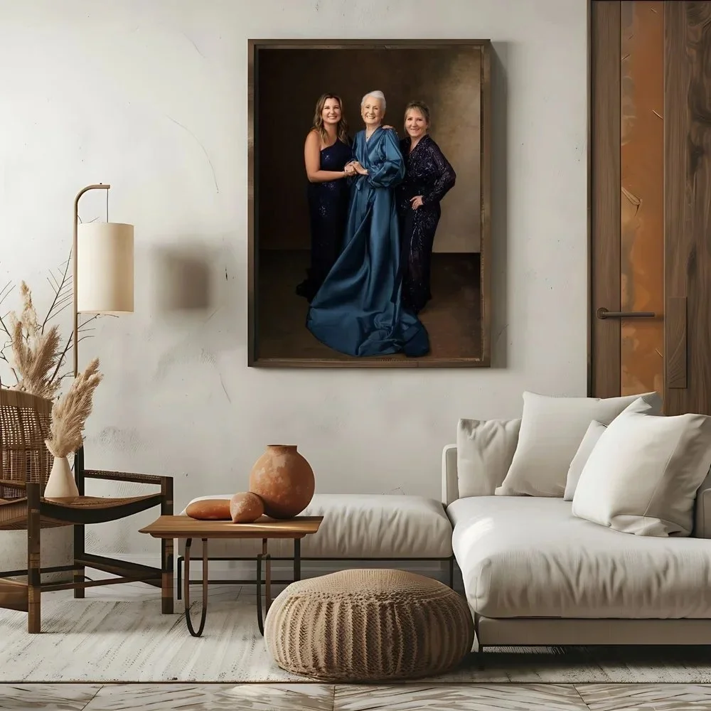 A living room with modern decor, a white sofa with pillows, a wooden chair with a cushion, a side table with decorative vases, a lamp, and a large painting of three women dressed in evening gowns hanging on the wall.
