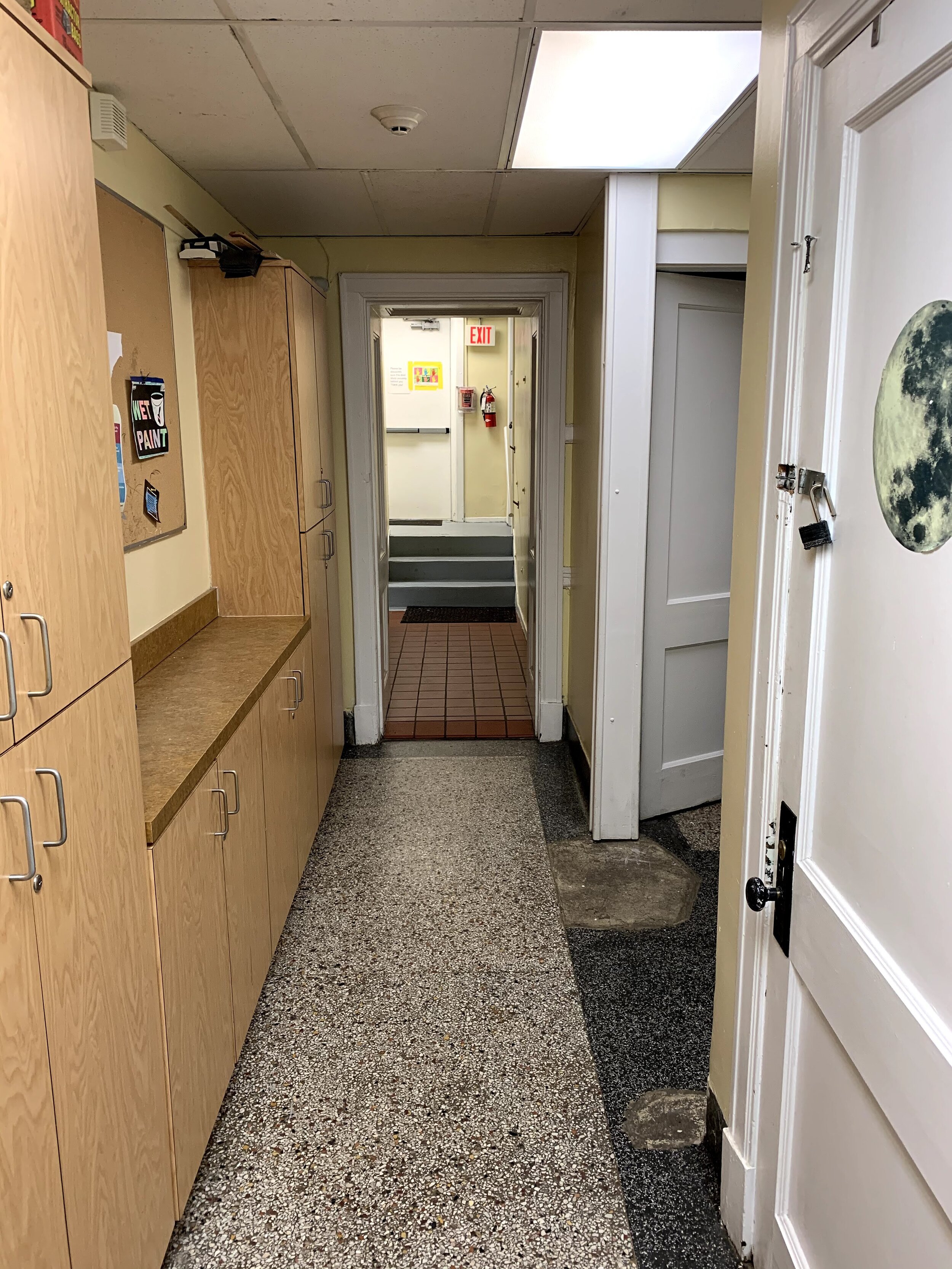 Basement hallway leading to laundry room and outdoor area.