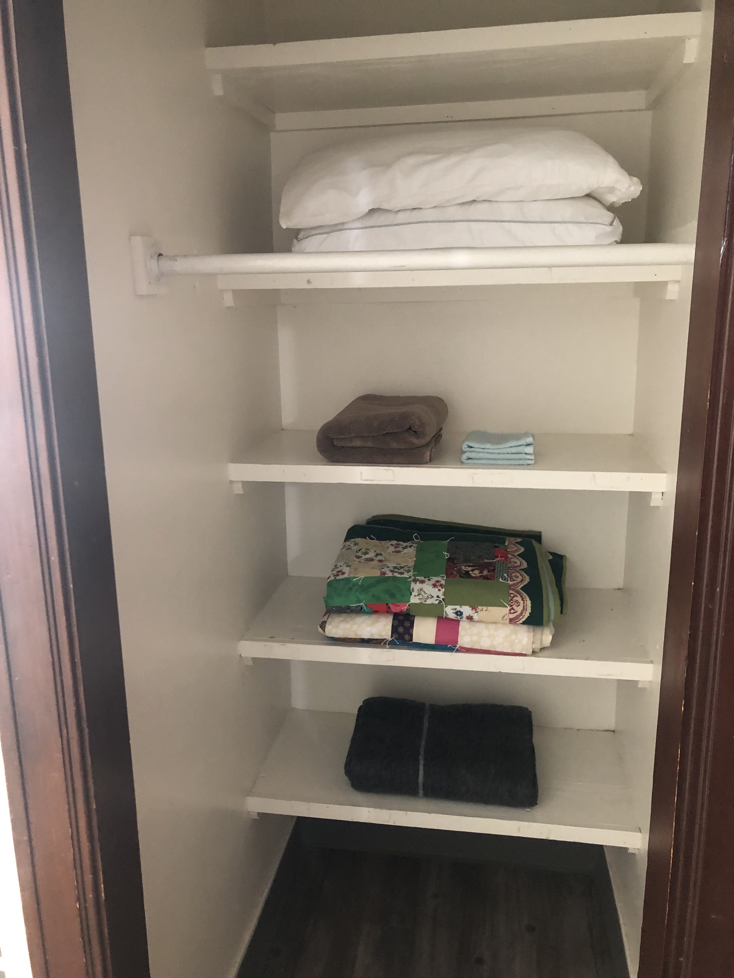 Large hanging and storage closet adjacent to room doorway. 