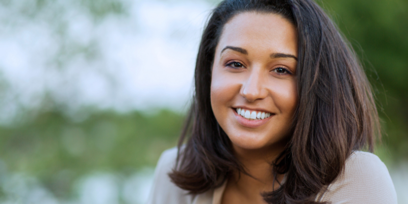 Woman Smiling Widely Showing Off Straight White Teeth and Attractive Gums
