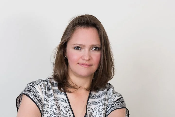 Photo of Isabel Melgarejo, Family Caregiver Coach and Planner, who has shoulder-length brown hair and brown eyes looking directly at the camera and a soft smile