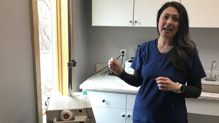 Debra McCarthy, a nurse at Ethos Clinic in Emmaus, explains how ketamine infusions are administered. (Binghui Huang/ Morning Call)