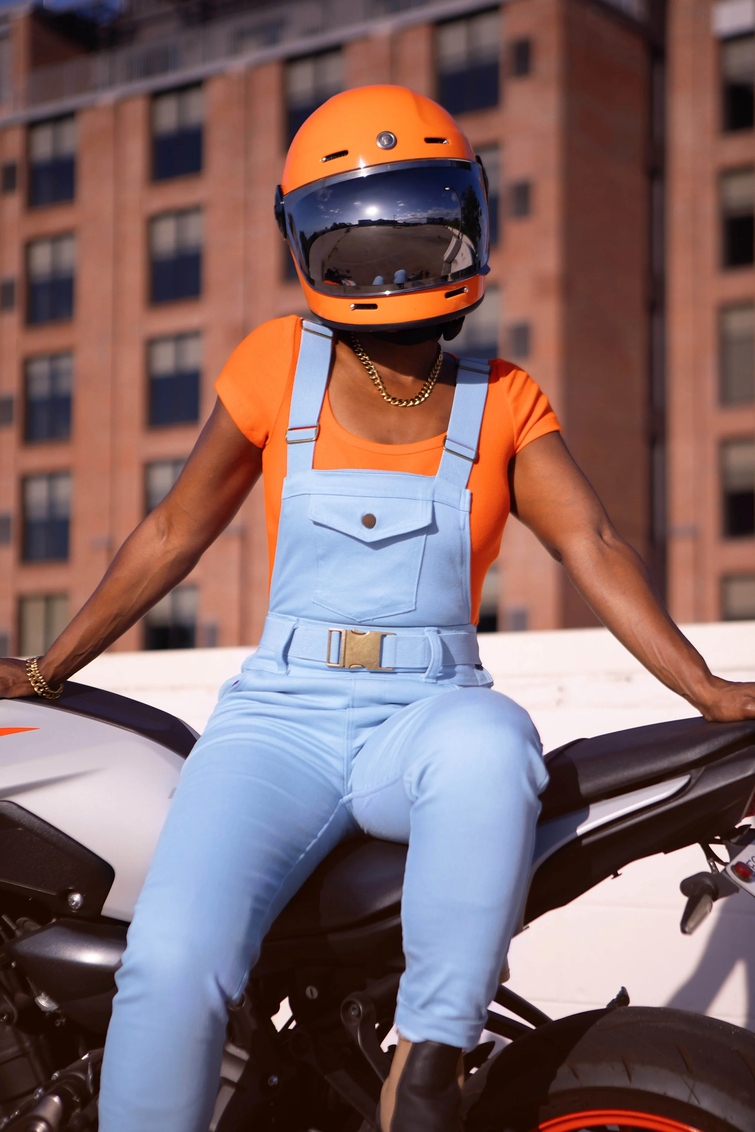 Chic-Riot-Christiana-Moto-Overalls-On-Top-Parking-Deck-Sitting-On-Bike.jpg