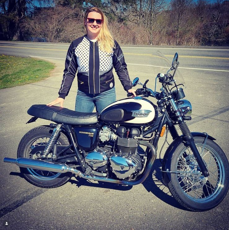 women standing in front of a motorcycle
