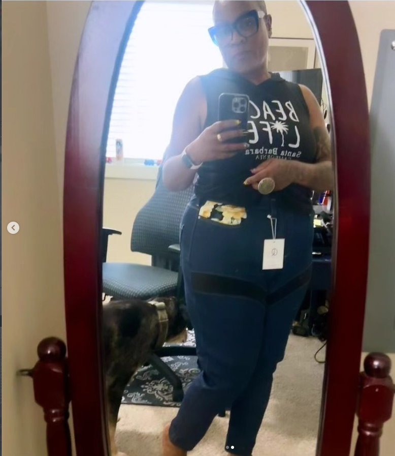 women looking at herself in the mirror wearing motorcycle jeans